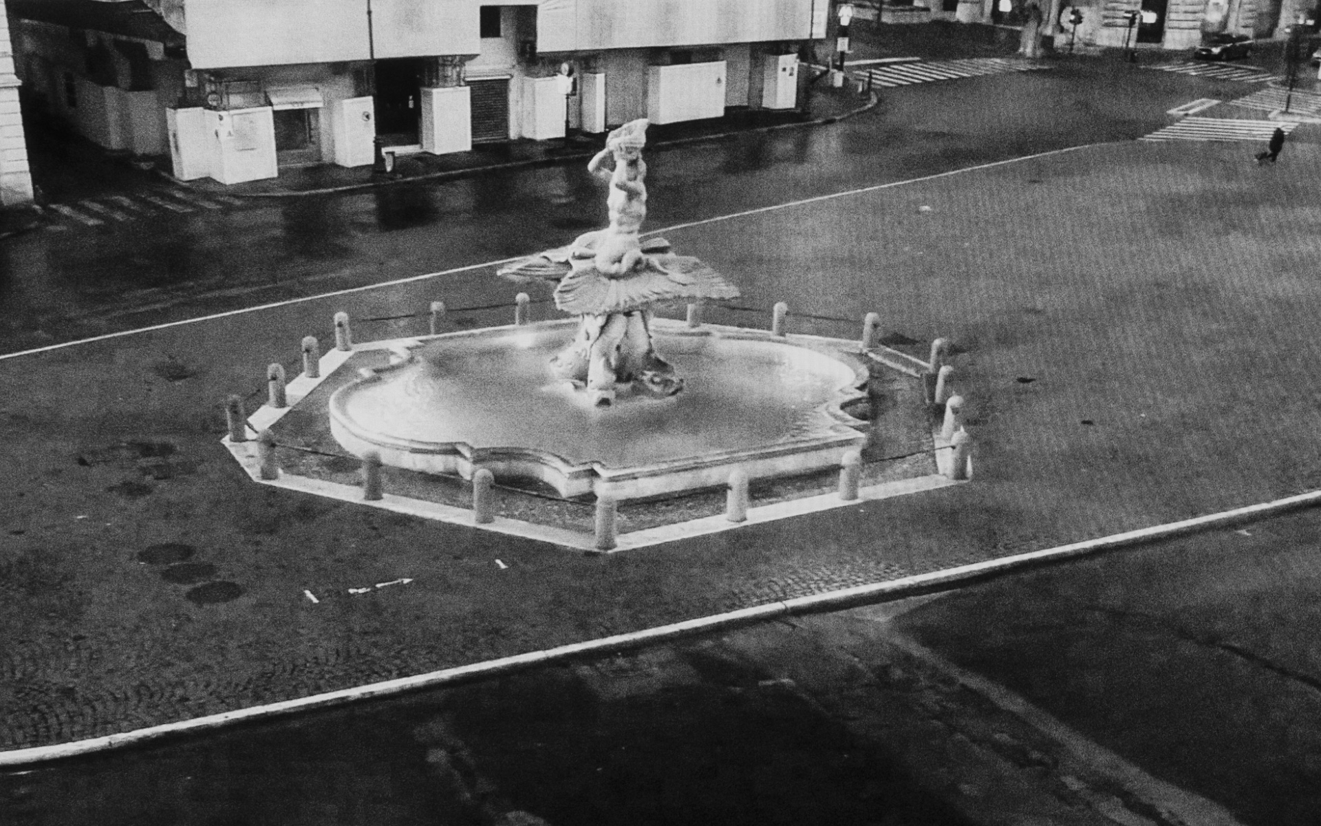 Rome, Barberini square - Triton fountain on depopulated Barberini Square in Rome, March 26. 2020.